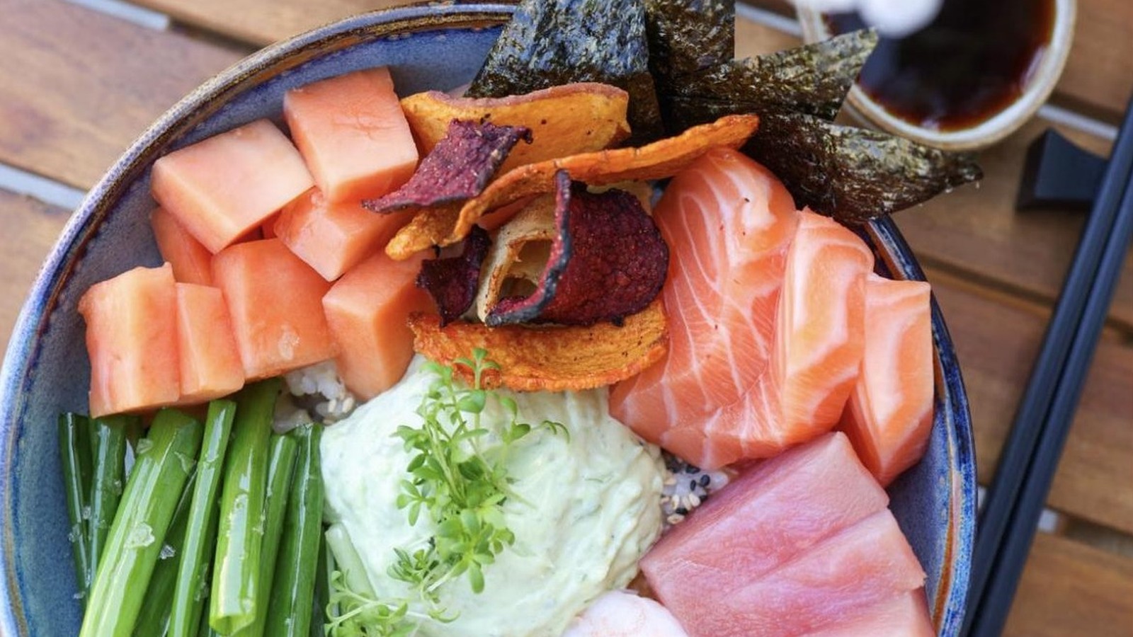 Illustrative stock photo of a poke bowl with salmon, tuna, and shrimp.