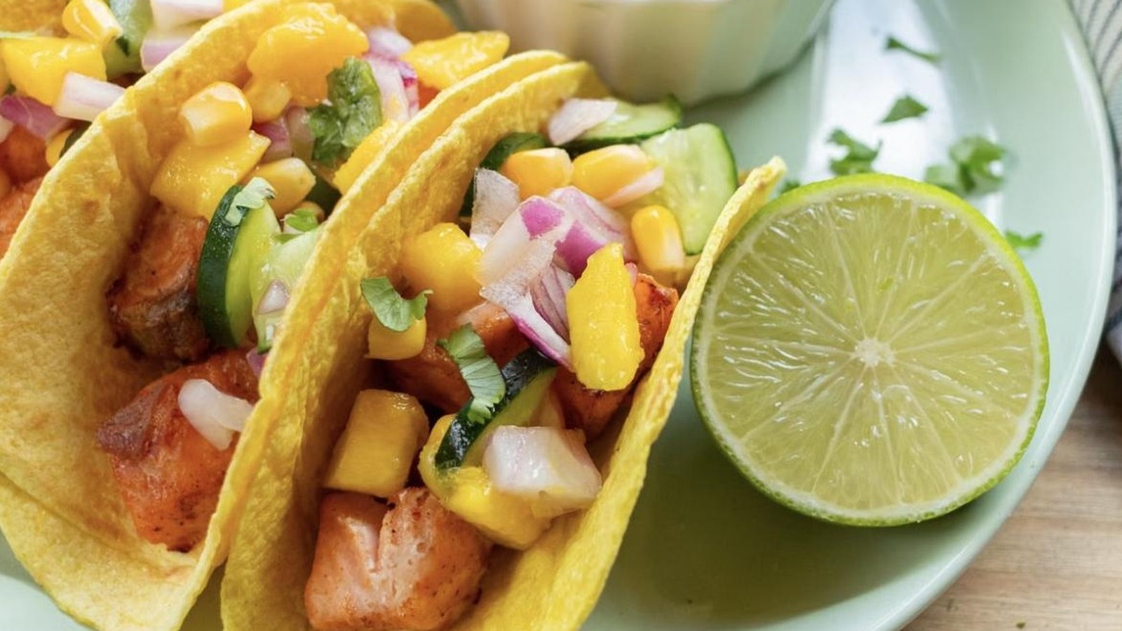 Illustrative stock photo of salmon tacos with mango salsa.