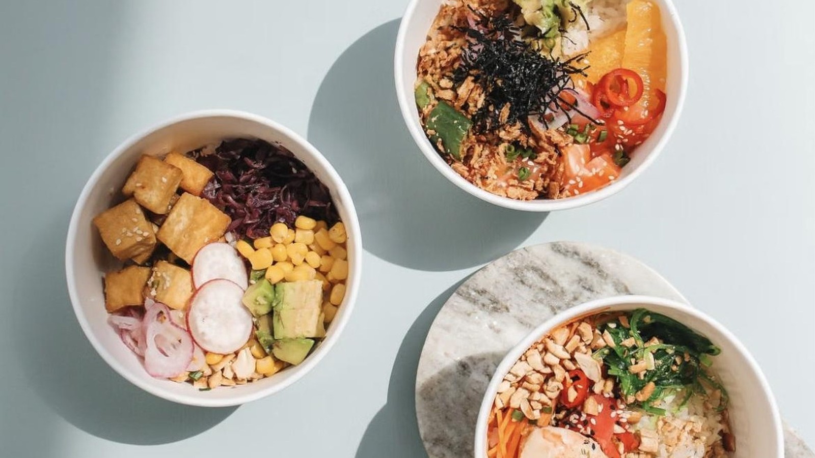Illustrative stock photo of three Hawaiian poke bowls.