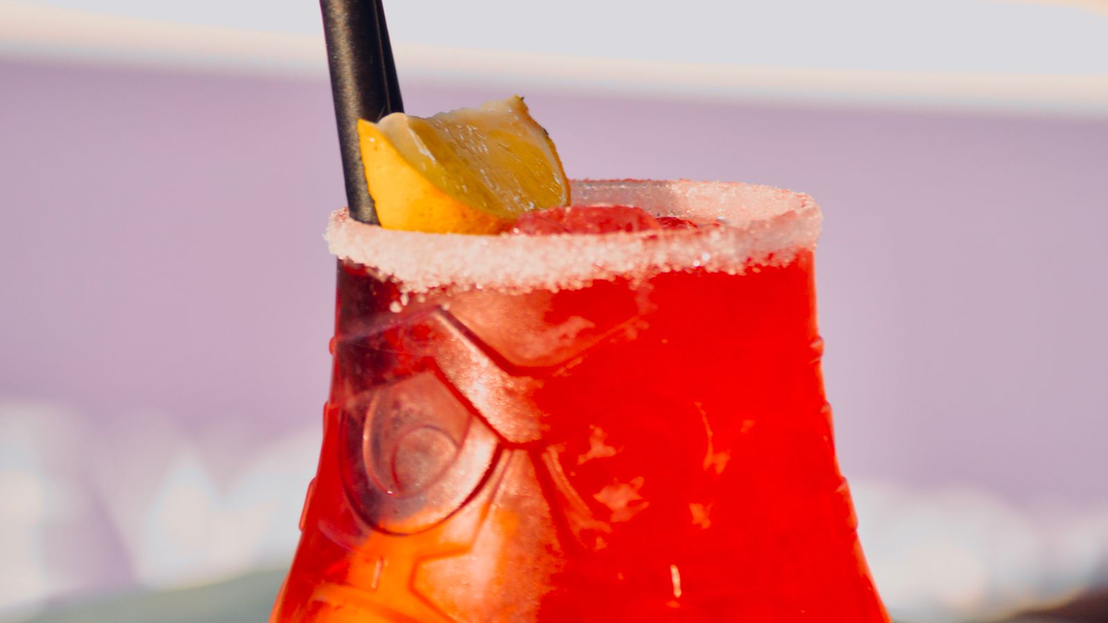 Illustrative stock photo of a red tiki cocktail with a lemon garnish.