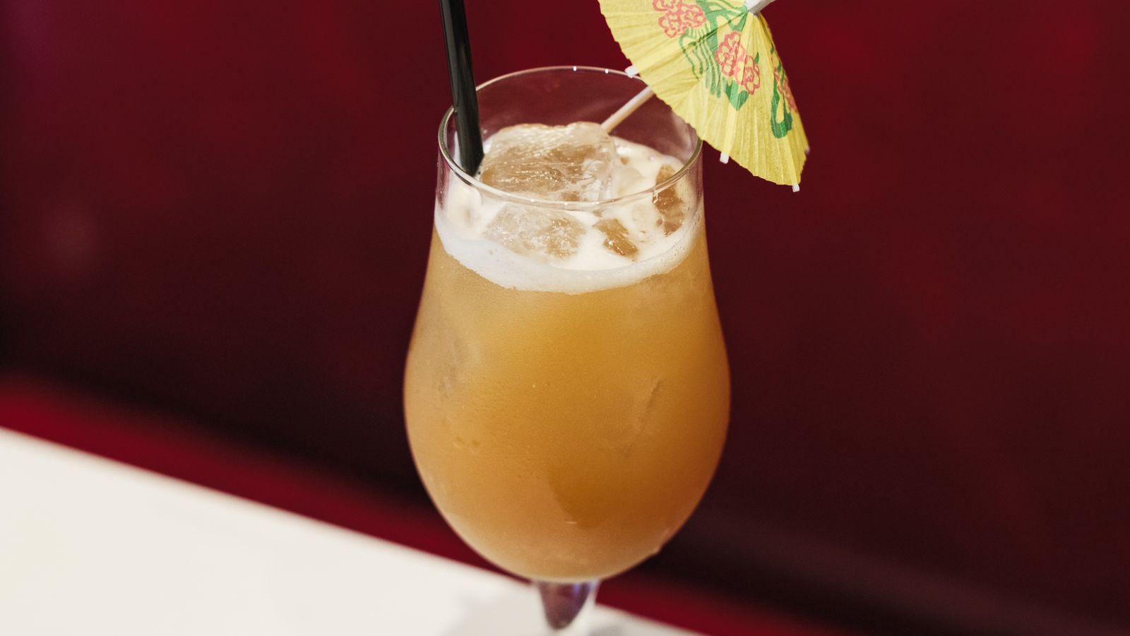 Illustrative stock photo of a tropical cocktail with a paper umbrella.